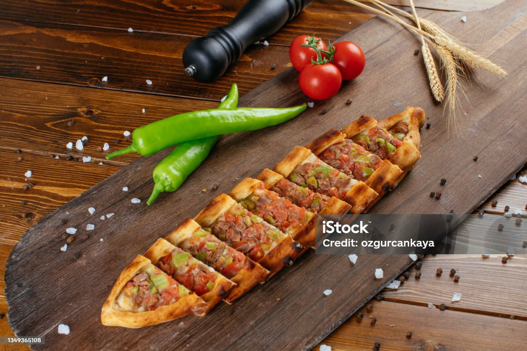 Traditional Turkish food, lahmacun and kiymali and kusbasili pide. Traditional Turkish pide with minced beef. Meaty Pita, thin piece of dough topped with minced meat. cooked in stone furnace. Nazilli , Aydin Pita Bread Stock Photo