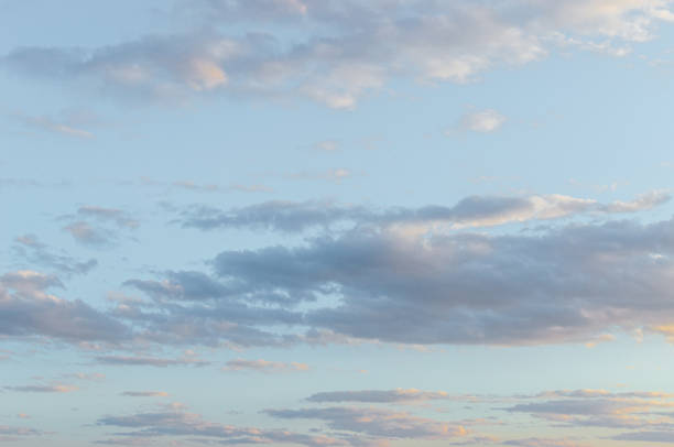istock fluffy clouds on a sunset background with dramatic light. Natural landscape. Copy space. 1349367925