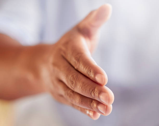 istock Cropped shot of an unrecognizable businessman gesturing for a handshake while standing in his office 1349367983