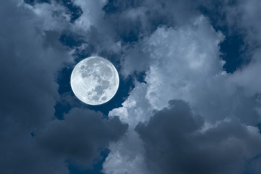 Full moon with clouds in the sky.