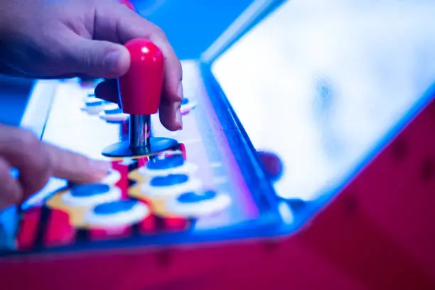 Close up shot of person playing with a arcade machine