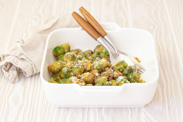 istock Vegetarian roasted brussels sprouts on white table 1349372100