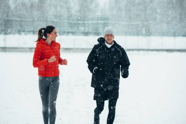 istock Young couple going for a run together during a snow 1349372469