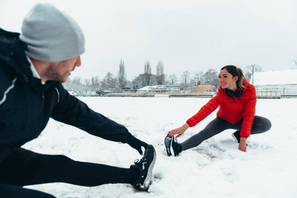 istock Young couple going for a workout together during a snow 1349372478