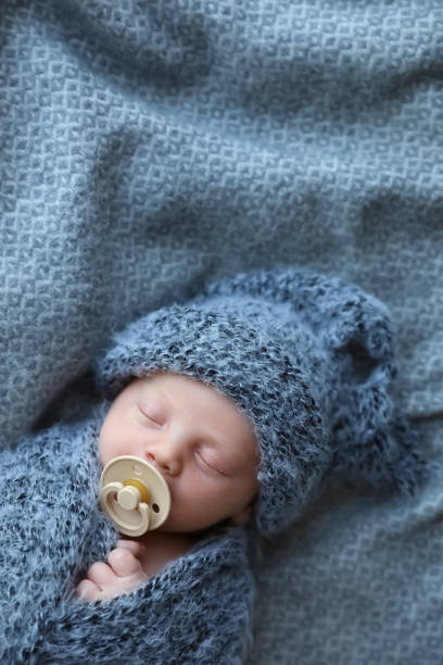 Cute newborn baby sleeping on blanket, top view. Space for text Cute newborn baby sleeping on blanket, top view. Space for text babyhood stock pictures, royalty-free photos & images