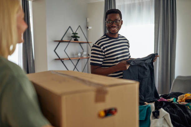 istock Diverse lovers helping each other for preparing their clothes for donations 1349373247