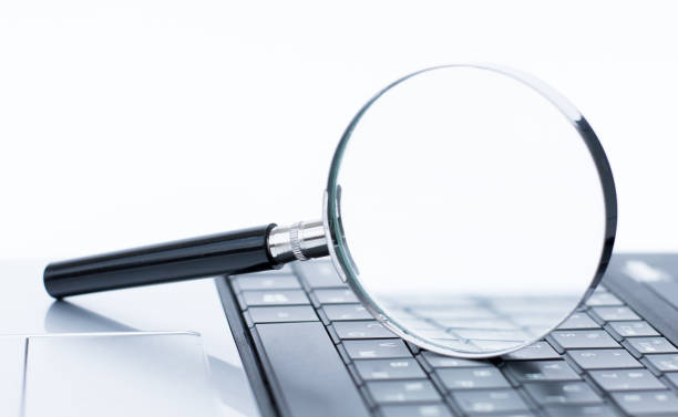 istock Search symbol background. Magnifying glass with empty white copy space. Laptop seeking information. 1349373330