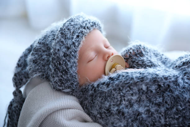 istock Cute newborn baby sleeping on plaid at home 1349373532