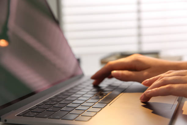 istock Woman working with modern laptop indoors, closeup 1349373649