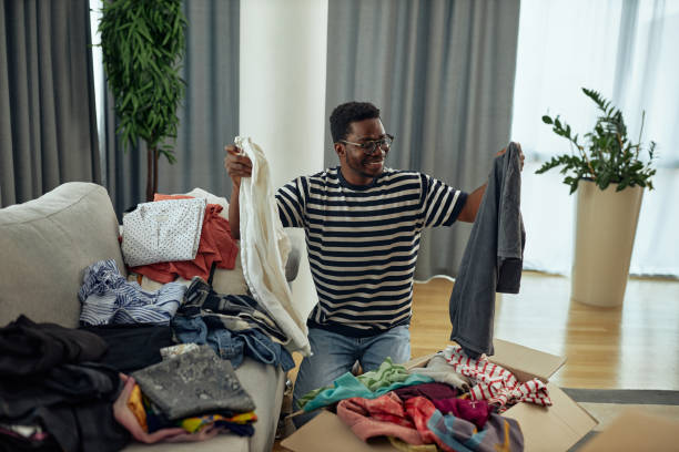 istock Black man donating some of his old clothes 1349373959