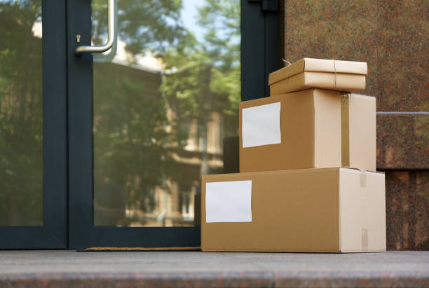 istock Delivered parcels on porch near front door 1349374735
