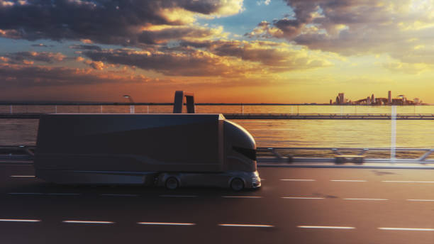 istock Futuristic Technology Concept: Autonomous Self-Driving Truck with Cargo Trailer Drives on the Road with Scanning Sensors. 3D Electric Lorry Driving Fast on Scenic Sunset Highway Bridge. 1349375111