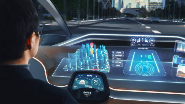 istock Futuristic Concept: Stylish Businessman Setting Location on an Interactive 3D Navigation App on an Augmented Reality Dashboard while Sitting in an Autonomous Self-Driving Zero-Emissions Electric Car. 1349375126