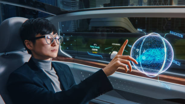 istock Futuristic Concept: Stylish Businessman Setting Location on an Interactive 3D Navigation App on an Augmented Reality Dashboard while Sitting in an Autonomous Self-Driving Zero-Emissions Electric Car. 1349375160