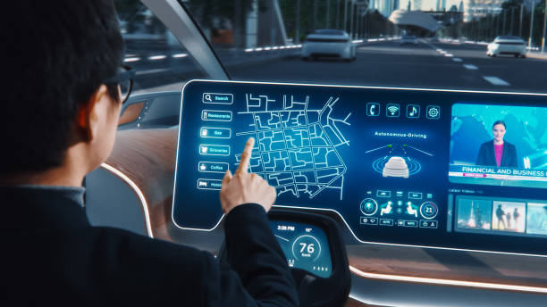 istock Futuristic Concept: Stylish Businessman Setting Location on an Interactive Navigation App on an Augmented Reality Dashboard while Sitting in an Autonomous Self-Driving Zero-Emissions Electric Car. 1349375175