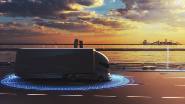 istock Futuristic Technology Concept: Autonomous Self-Driving Lorry Truck with Cargo Trailer Drives on the Road with Scanning Sensors. Special Effects of a Vehicle Analyzing Highway on a Sunset Evening. 1349375220