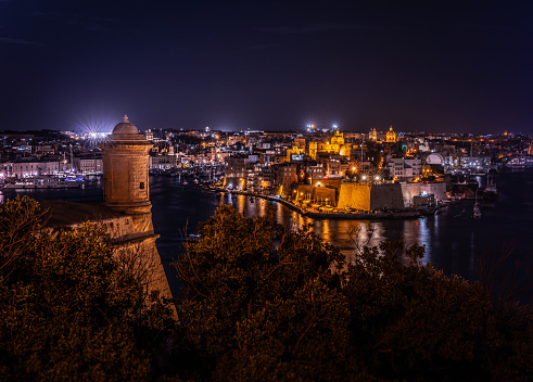 View to marina in Il-Birgu in night, Valletta on background, Malta