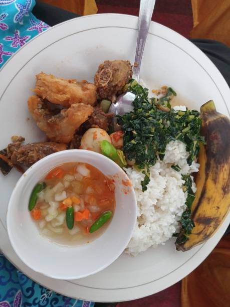 istock a plate of rice, fried chicken, vegetables, pickles and bananas 1349376603