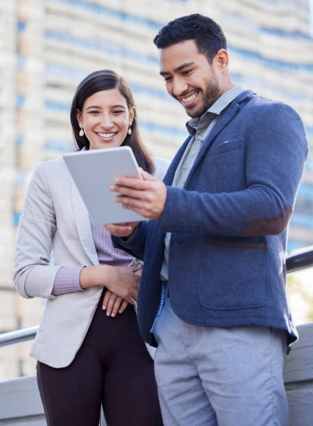 istock Shot of two coworkers using a digital tablet together 1349376765