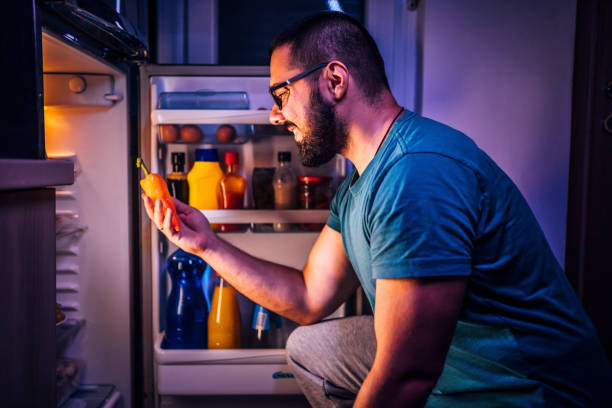 istock Man taking the pepper out of the fridge 1349376775