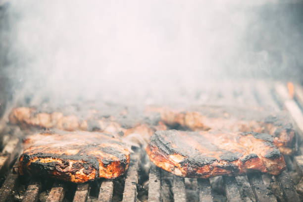 istock meat steak fried on a wire rack with smoke and fire 1349378891