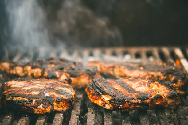 istock meat steak fried on a wire rack with smoke and fire 1349378896