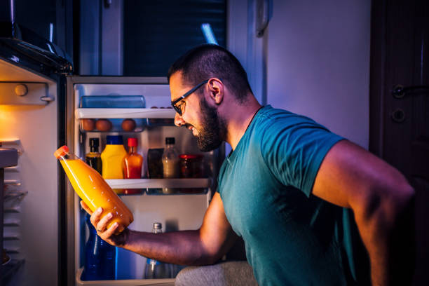 istock Man taking juice out of refrigerator 1349379117
