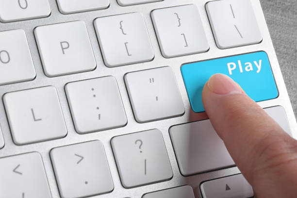 istock Woman pressing button Play on computer keyboard, closeup. Online games concept 1349379388