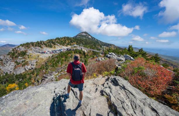 istock Hiker man standing on a cliff edge enjoying scenic view. 1349380069