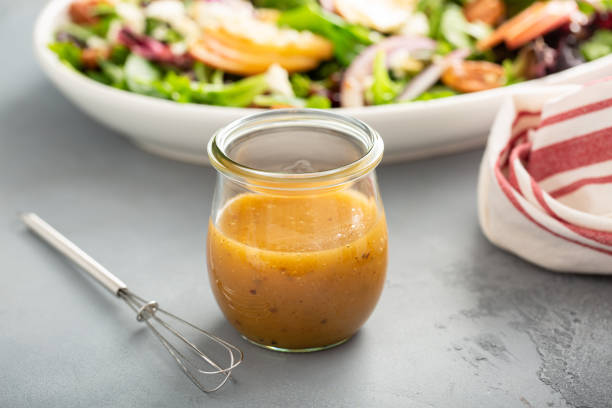 Apple vinaigrette salad dressing Apple cider vinaigrette salad dressing in a mason jar mustard fruits stock pictures, royalty-free photos & images