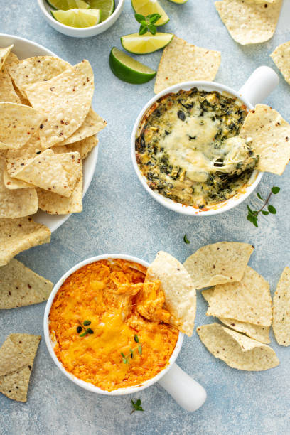 Artichoke spinach and buffalo chicken dips with chips Artichoke spinach and buffalo chicken dips served with tortilla chips, appetizers dipping sauce stock pictures, royalty-free photos & images
