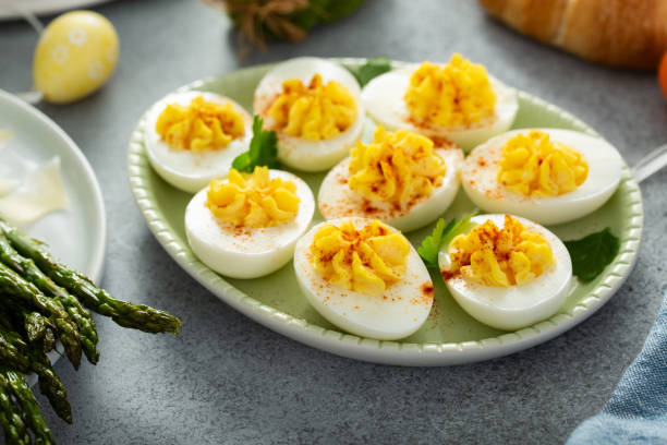 Traditional deviled eggs for Easter brunch Traditional deviled eggs with paprika for Easter brunch stuffed photos stock pictures, royalty-free photos & images