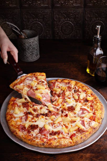 istock Hawaiian pizza with ham and pineapple 1349383866