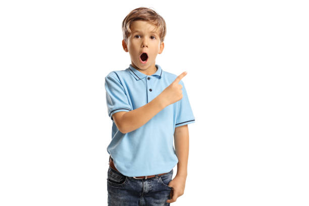 istock Surprised little boy with open mouth pointing to the side 1349385804