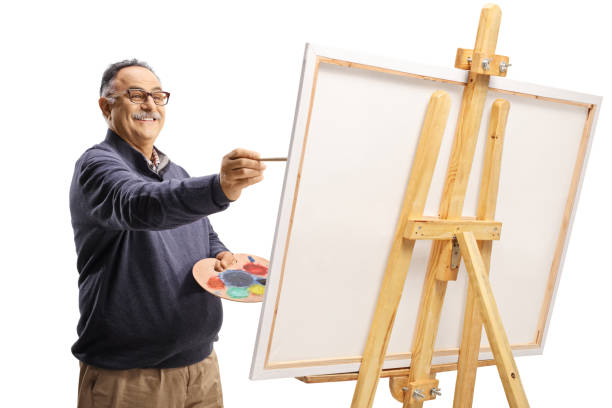 istock Smiling mature man painting on a canvas 1349385807