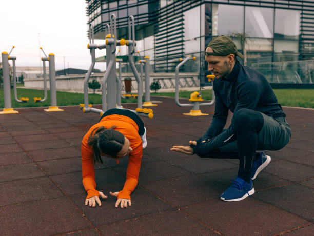 istock Young man and a woman help each other on the training 1349386477