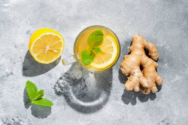 istock Ginger root, lemon tea and mint with dark shadows top view 1349389474