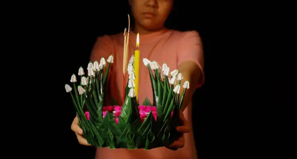 Photo of A girl handle banana leaved floating basket or Krathong called in Thai , Loy Kratong Festival in Thailand be held every full moon of November