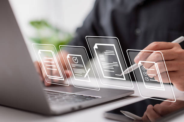 Paperless workplace idea, e-signing, electronic signature, document management. Businessman signs an electronic document on a digital document on a virtual notebook screen using a stylus pen. Paperless workplace idea, e-signing, electronic signature, document management. Businessman signs an electronic document on a digital document on a virtual notebook screen using a stylus pen. plan document stock pictures, royalty-free photos & images