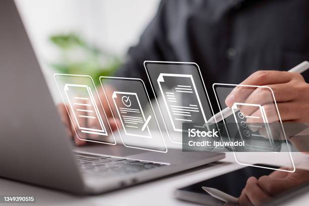 Paperless Workplace Idea Esigning Electronic Signature Document Management Businessman Signs An Electronic Document On A Digital Document On A Virtual Notebook Screen Using A Stylus Pen Stock Photo - Download Image Now