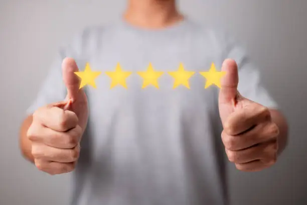 Photo of Concept of Customer Experience. With a five-star rating, a happy client gives a thumbs up for great. Excellent Services for Customer Satisfaction.