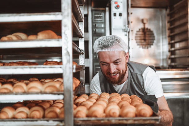 istock Happy Baker Satisfied With Freshly Baked Croissants 1349390988