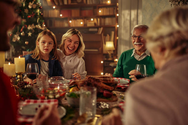 istock Joyful family celebrating Christmas at dining table. 1349398196