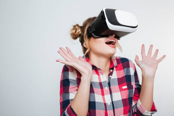 istock Surprised Woman in shirt using virtual reality device 1349398335