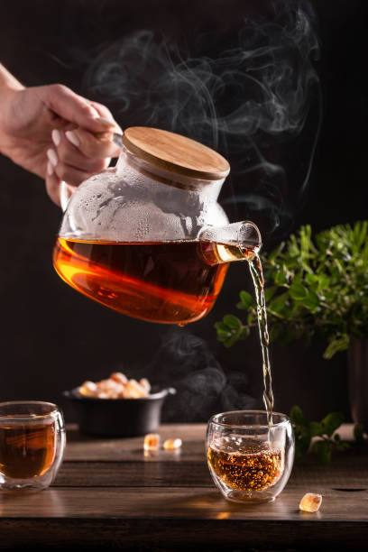 istock Black hot tea with sugar lollipops on a wooden table 1349400715