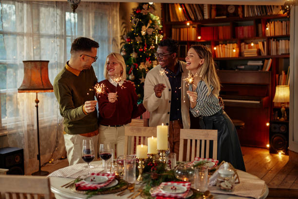 istock Group of friends playing with sparklers at home while celebrating holidays 1349405685