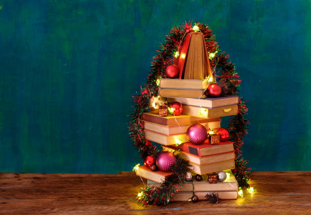 Giving books for christmas with stack of books forming a christmas tree.Reading,literature,education,gift,present,christian holiday concept stock photo