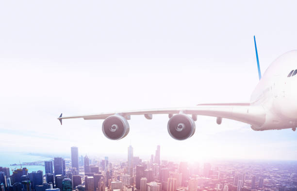 istock Wing of big jet airplane fly over Chicago downtown 1349410521