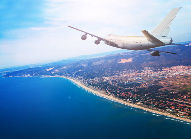 istock Big jet airplane fly over Mediterranean coast 1349410663