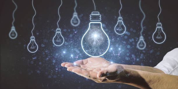 istock Hands holding abstract light bulbs on dark background with circuit man. Artificial intelligence, idea, technology and innovation concept. 1349412087